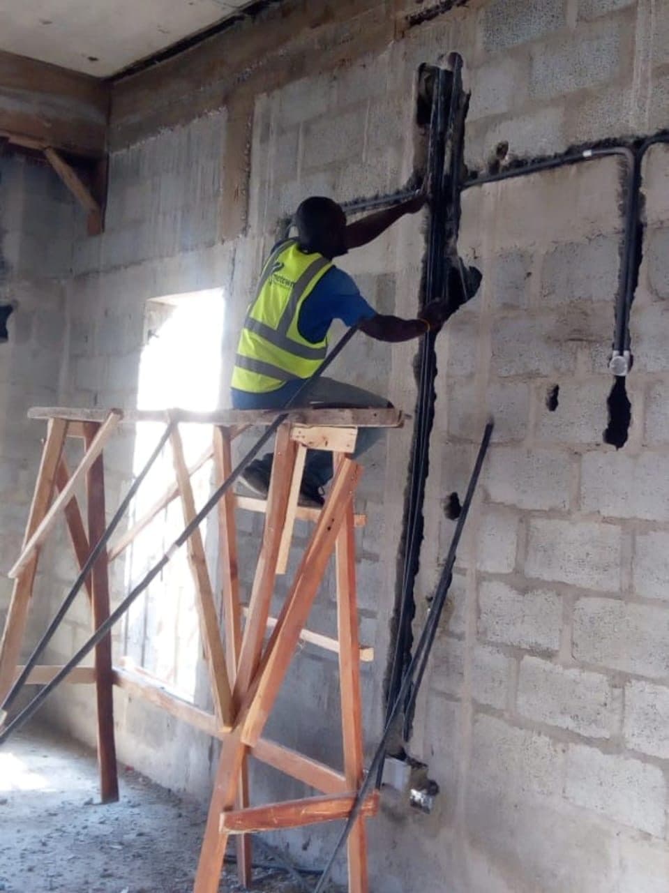 Vertical conduit drop on blockwork